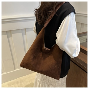 Brown frosted suede hobo bag shown in a lifestyle setting on a model's shoulder
