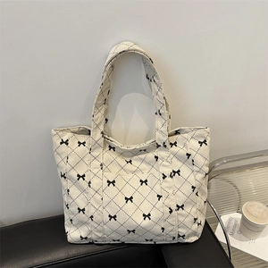Large cream corduroy tote bag with black bow patterns for commute work and travel