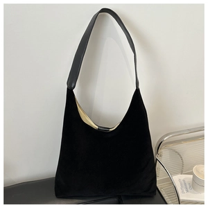 Detail of minimalist black frosted suede hobo bag with contrast strap and light lining