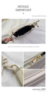 Detail of off-white leather handbag showing gold zipper and knot strap design