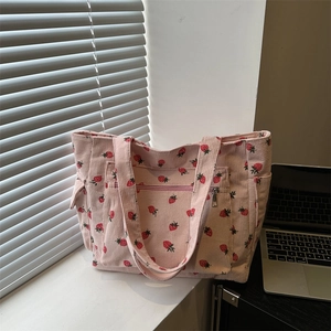 Pink corduroy tote bag with strawberry prints featuring multiple pockets and zipper
