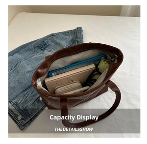 Internal capacity of brown leather tote bag showing space for tablet and essentials