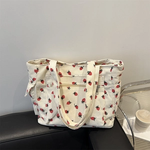Minimalist cream corduroy tote bag with red strawberry print and multi-pocket design