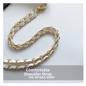 Detail of gold metal chain woven with white leather and spring hook for shoulder bag