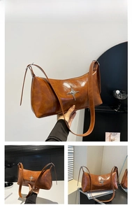 Close-up of brown polished oil wax leather shoulder bag with silver star metal ornament