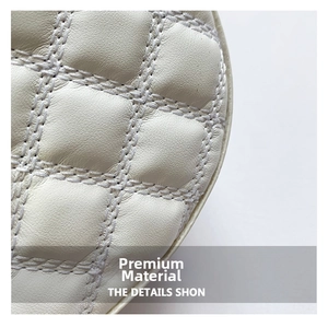 Macro view of ivory quilted leather with classic diamond stitching and lychee texture
