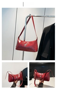 Detail of red patent leather shoulder bag featuring a silver star metallic ornament