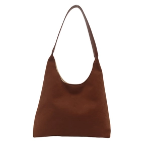 Minimalist brown suede hobo bag with sleek shoulder strap on a white background