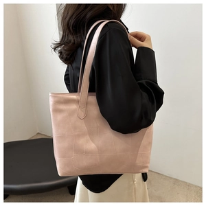 Detailed texture of pink geometric tote bag on shoulder with minimalist fashion look