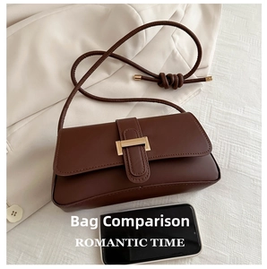 Close-up of small brown retro crossbody bag with gold buckle and phone size comparison