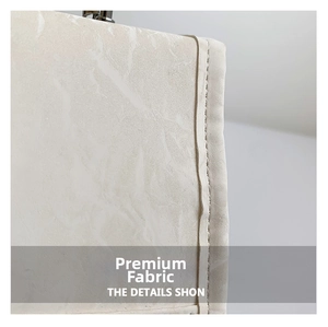 Macro view of creamy white square bag showing premium marble texture and stitching details