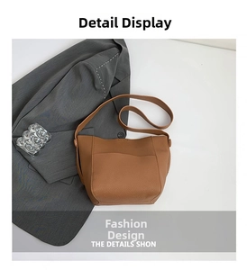 Detailed macro view of caramel pebble leather texture and stitching on bucket shoulder bag