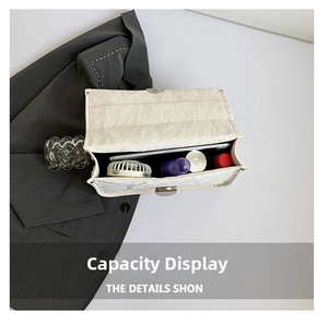 Spacious interior of white minimalist bag showing capacity for phone and cosmetics