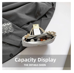 Interior view of white quilted crossbody bag showing space for phone and cosmetics