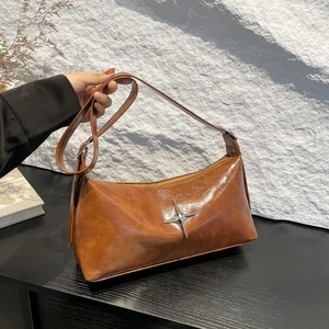 Vintage brown glossy leather underarm bag with silver star accent and adjustable strap