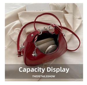 Interior view of the red patent leather crescent bag showing daily storage capacity