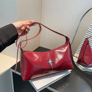 Deep red vintage leather shoulder bag with silver star buckle and adjustable strap