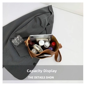 Top view of brown leather bucket bag showing large capacity for tablet and cosmetics