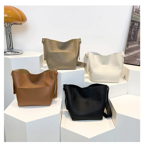 Litchi pattern shoulder bags in caramel, khaki, ivory, and black colors on display