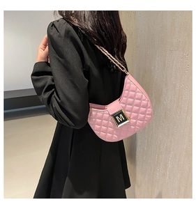 Detail of pink quilted shoulder bag with gold M-logo buckle and chain strap