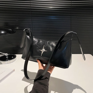 Glossy black leather crossbody bag featuring a silver star buckle and adjustable strap