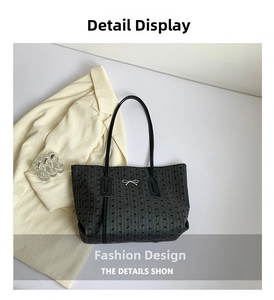 Detail of black tote bag featuring delicate bow print and elegant silver bow accent