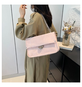 Detail of light pink square flap bag showing micro-wrinkle texture and silver chain strap
