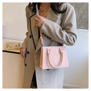 Pink marble texture tote bag shown on model with adjustable strap and dual handles