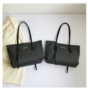 Detailed comparison of gray polka dot tote bags with metal bow accent and slim straps