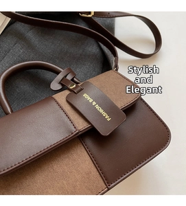 Detail of a brown patchwork handbag with gold-tone fashion tag and textured leather finish