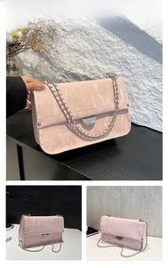 Detailed close-up of pink marble pattern bag with silver chain and metal buckle