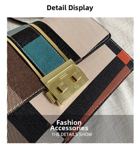 Close-up of color-block plaid fabric texture and golden metal pig nose lock detail
