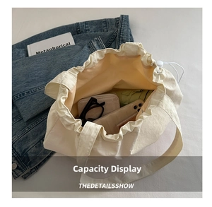 Overhead shot of spacious cream canvas tote bag interior with drawstring closure