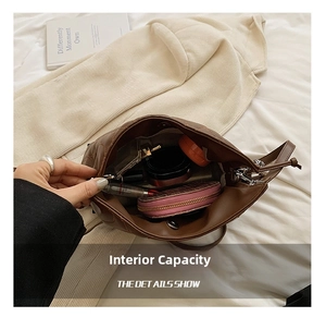 Internal view of brown quilted tote bag showing spacious capacity with cosmetics and wallet