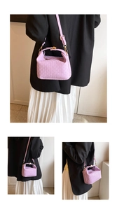 Detail of purple woven texture mini crossbody bag with gold hardware and strap