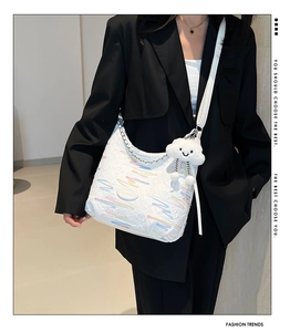 White textured shoulder bag with colorful embroidery and a cute cloud plush pendant