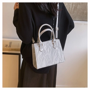 Chic light gray pleated PU crossbody bag with adjustable strap shown on model side view