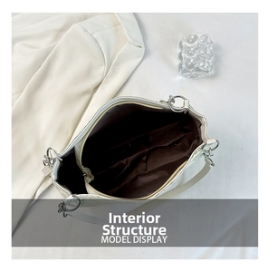 Internal structure of cream shoulder bag with brown fabric lining and zip compartments