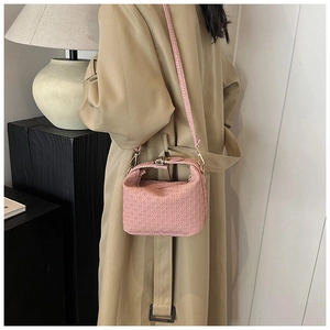 Pink woven crossbody bag with detailed letter pattern embroidery and elegant shoulder strap
