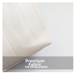 Macro shot showing the detailed herringbone texture of the premium white leather tote bag