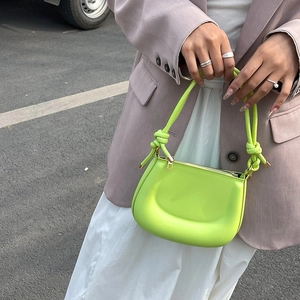 Bright green crescent moon shoulder bag with knotted handle and golden hardware for women