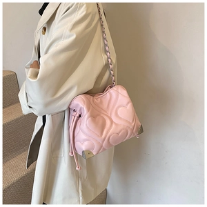 Pink heart quilted tote bag detail with chain strap and silver metal corner protectors