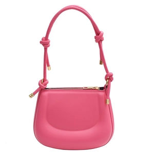 Hot pink saddle shoulder bag with elegant knot details and golden metal hardware