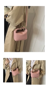 Pink textured crossbody bag with gold hardware and stylish woven leather pattern detail