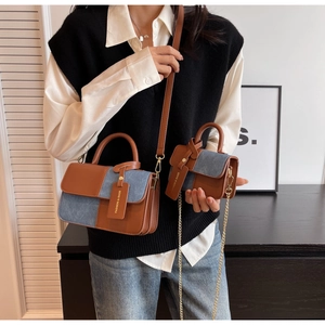 Detail of color-block flap bag and mini handbag with blue denim and brown leather stitching