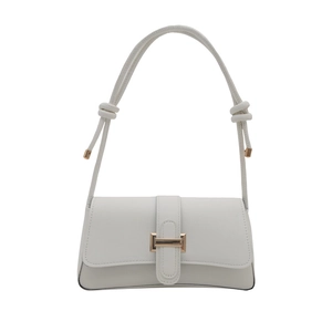 Minimalist white leather shoulder bag with decorative strap knots and gold metal hardware