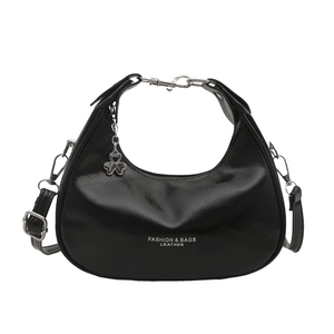 Glossy black crescent shoulder bag with silver chain handle and clover charm detail