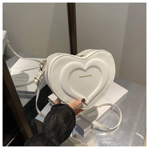 Dettaglio borsa bianca a forma di cuore con scritte dorate e trama in ecopelle liscia