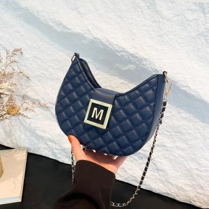 Quilted navy blue crescent bag with gold chain strap and M-buckle detail for women