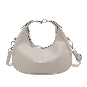 Chic beige crescent moon handbag with silver butterfly charm and adjustable shoulder strap